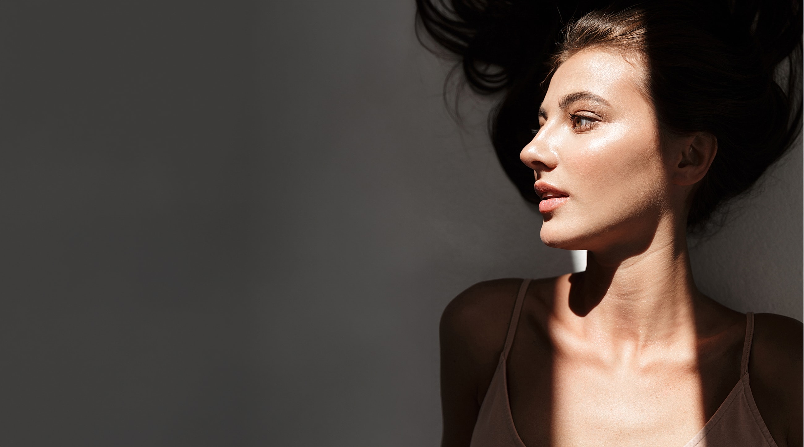 Profile of a Salt Lake City med spa model with flowing hair.