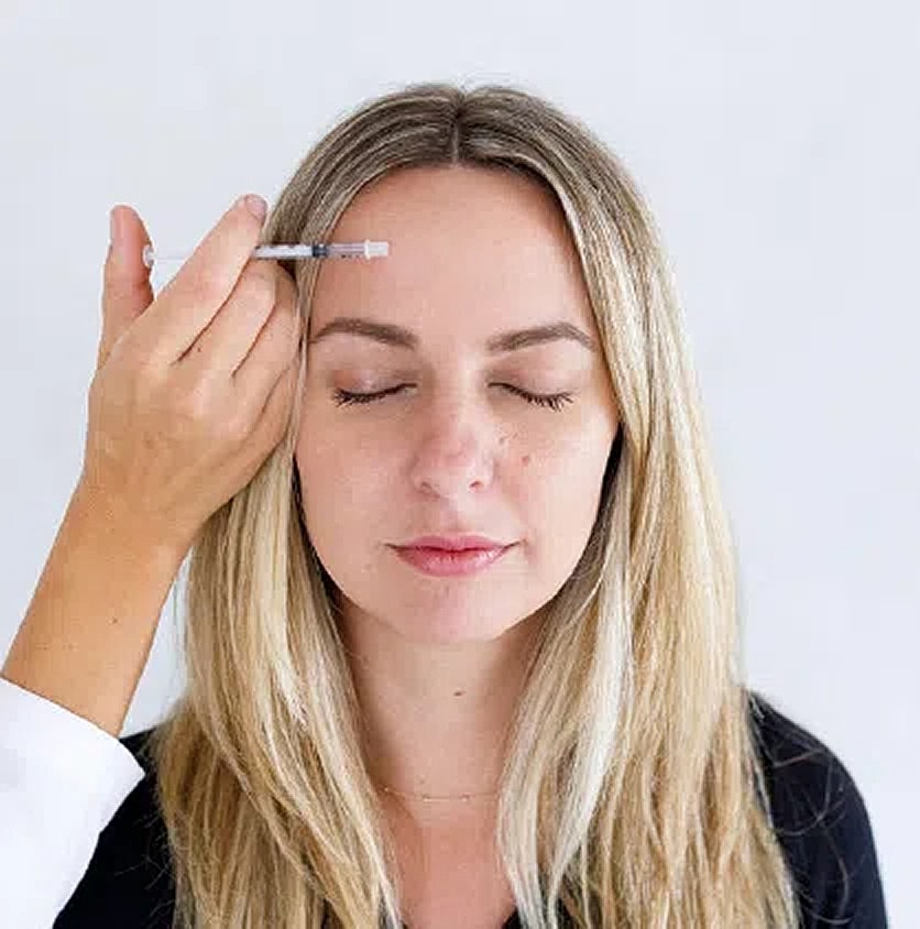 Woman receiving facial treatment in spa setting.