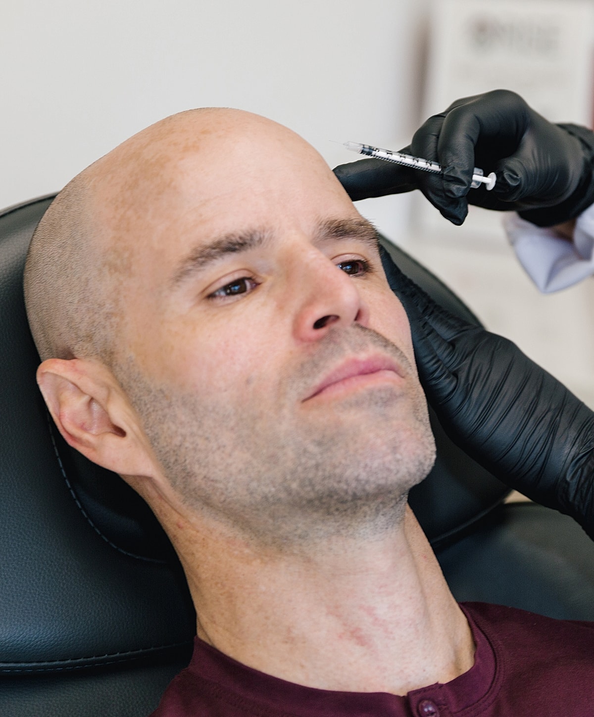 Man receiving an injection in a clinic setting.