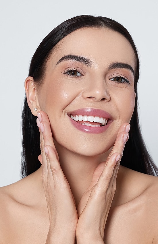 Smiling Salt Lake City med spa model with healthy, glowing skin.