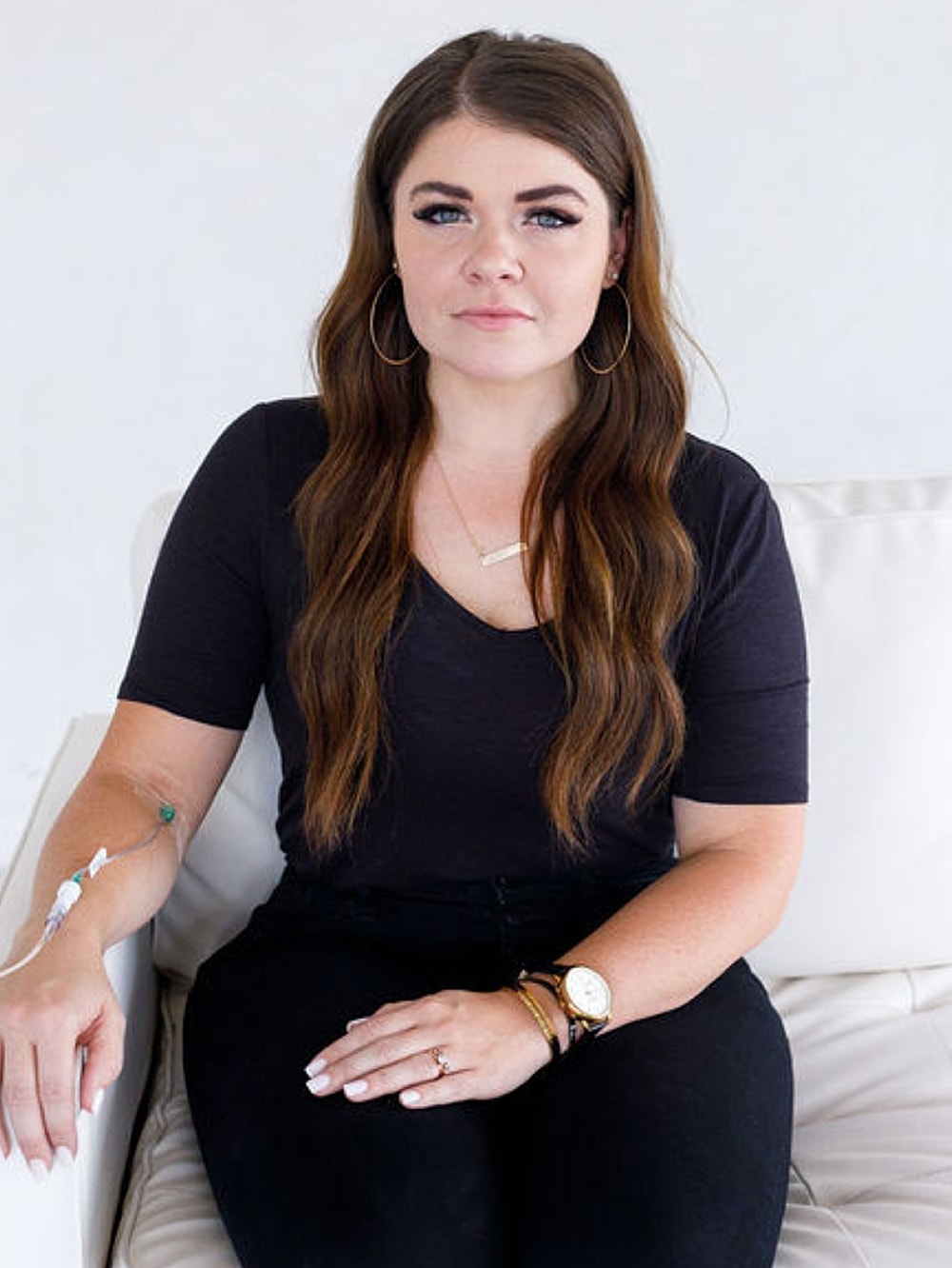 Salt Lake City med spa model sitting with medical IV line in arm.