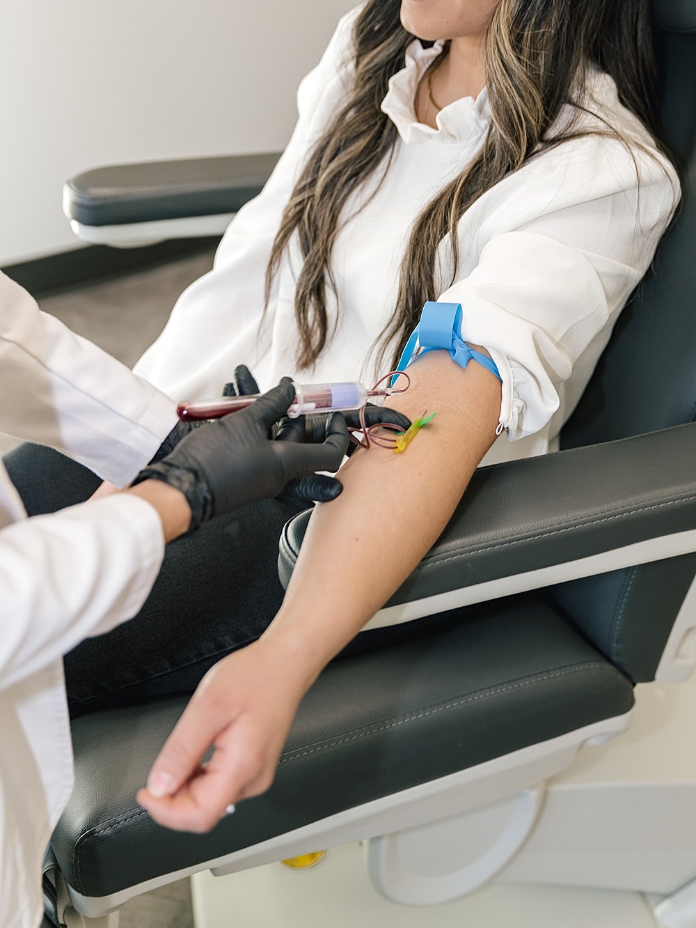 Salt Lake City med spa model receiving blood draw in medical setting.