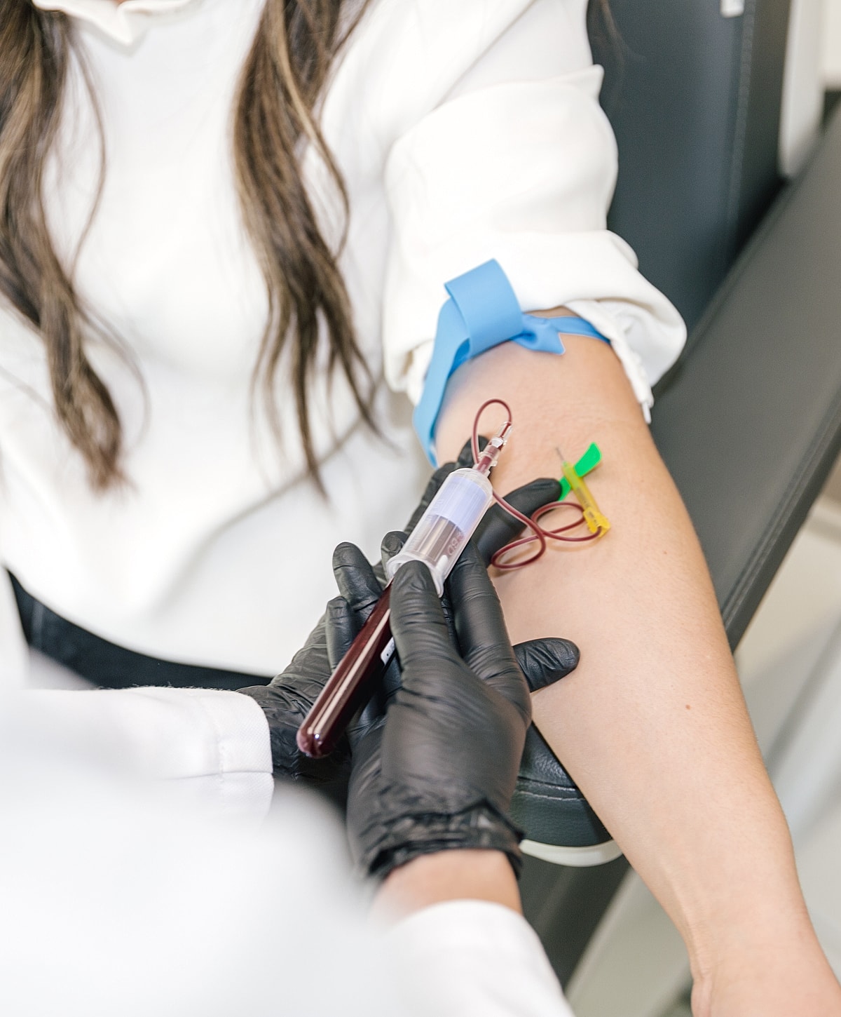 Blood draw procedure in a clinical setting.