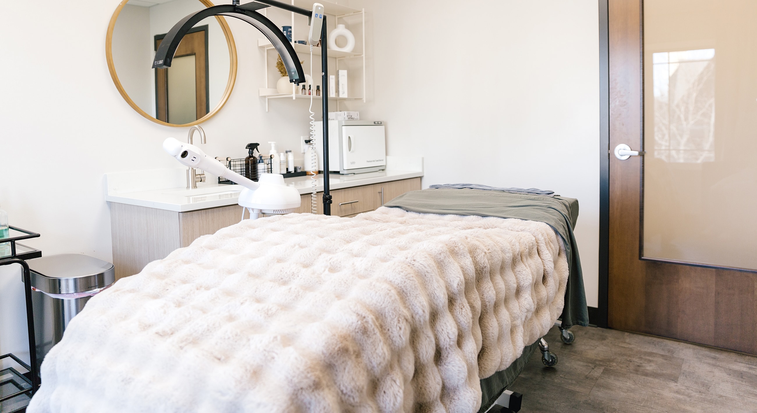 Spa treatment room with cozy massage bed.